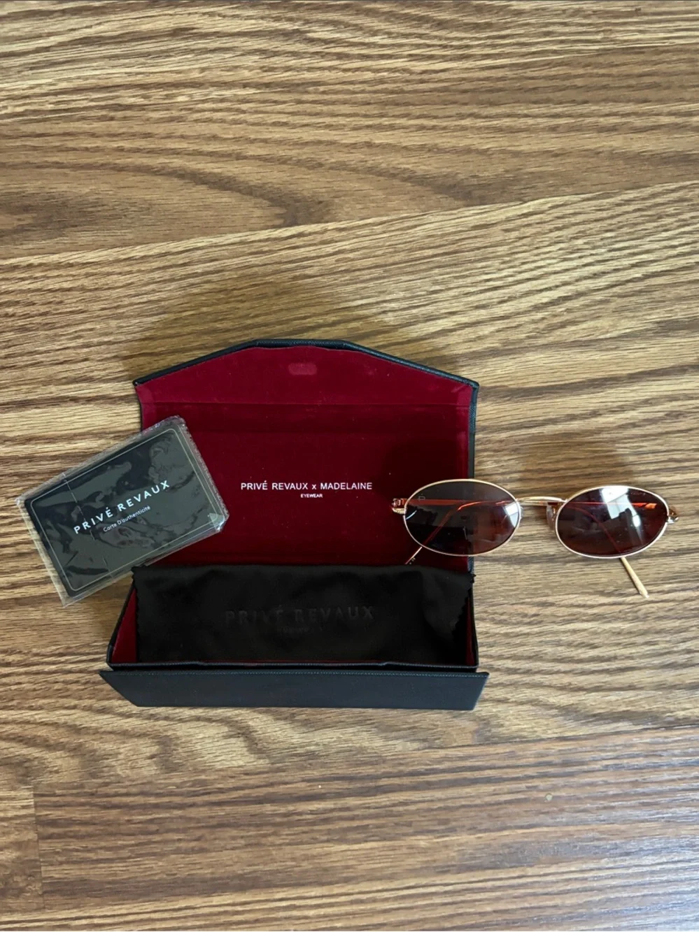 Red-tinted sunglasses with gold frame